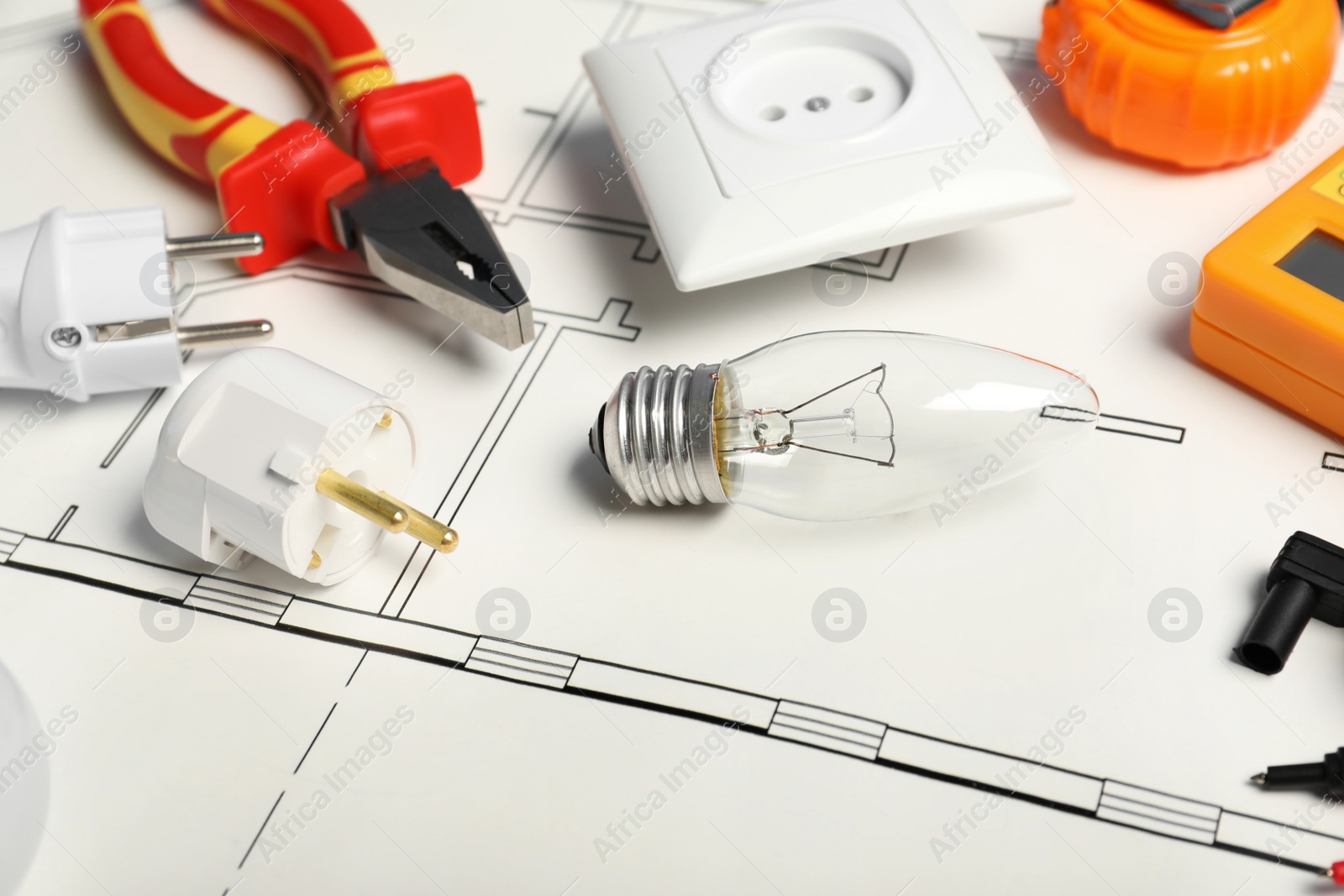 Photo of Set of electrician's tools on house plan