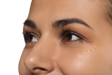 Woman with eye cream on white background, closeup. Skin care