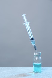 Photo of Syringe and vial on light grey table