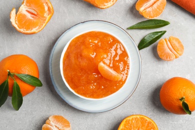 Photo of Flat lay composition with delicious tangerine jam on light grey table