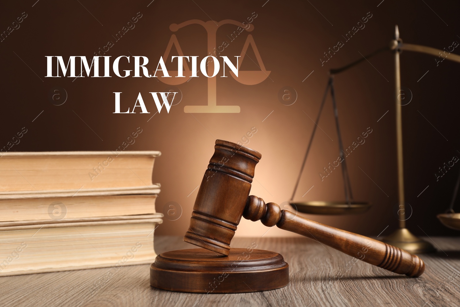 Image of Immigration law. Judge's gavel, scales of justice and books on wooden table against brown background