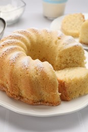 Photo of Delicious freshly baked sponge cake on white table, closeup