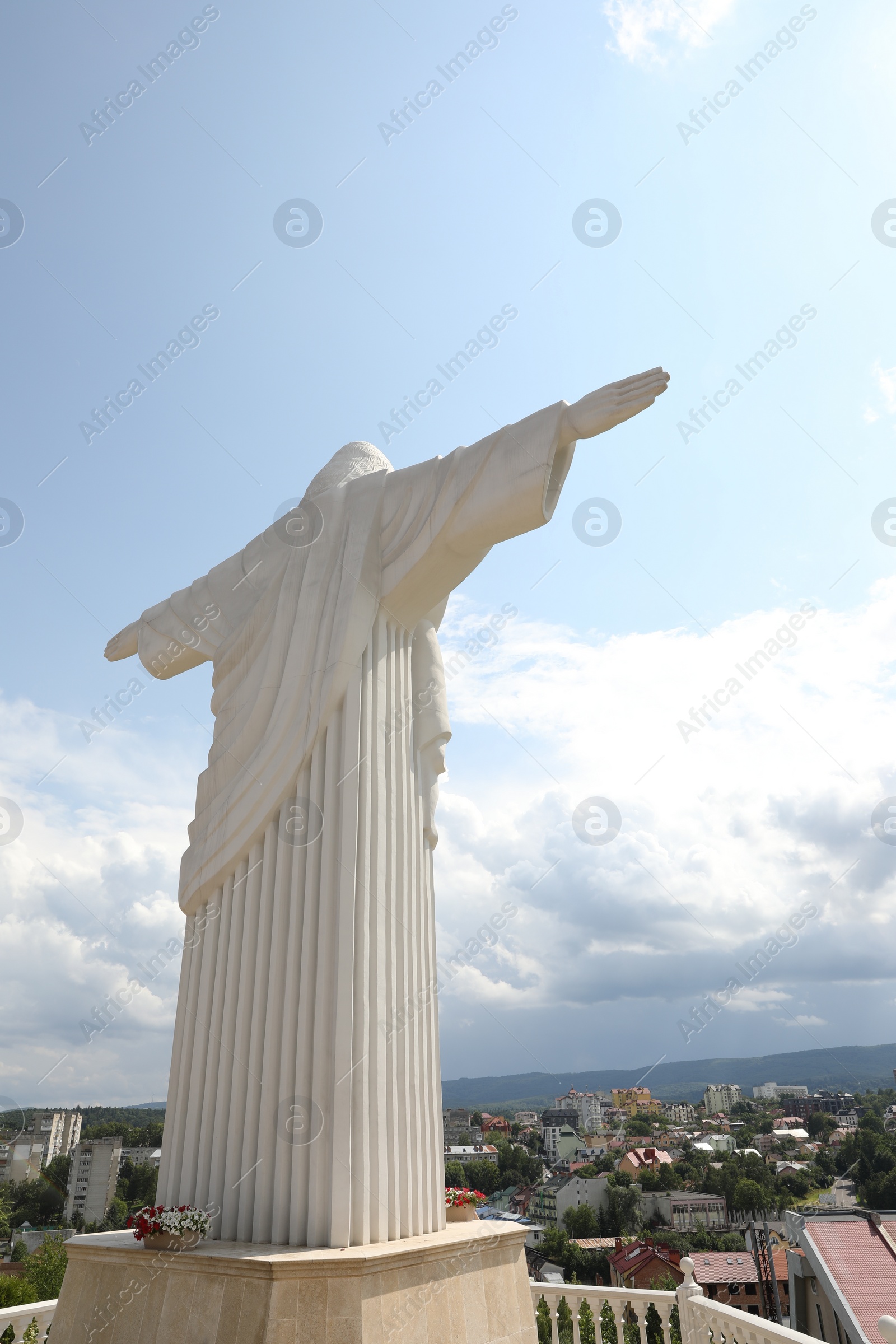 Photo of Truskavets, Ukraine - July 22, 2023: Statue of Christ the Redeemer against beautiful cityscape