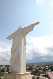 Photo of Truskavets, Ukraine - July 22, 2023: Statue of Christ the Redeemer against beautiful cityscape