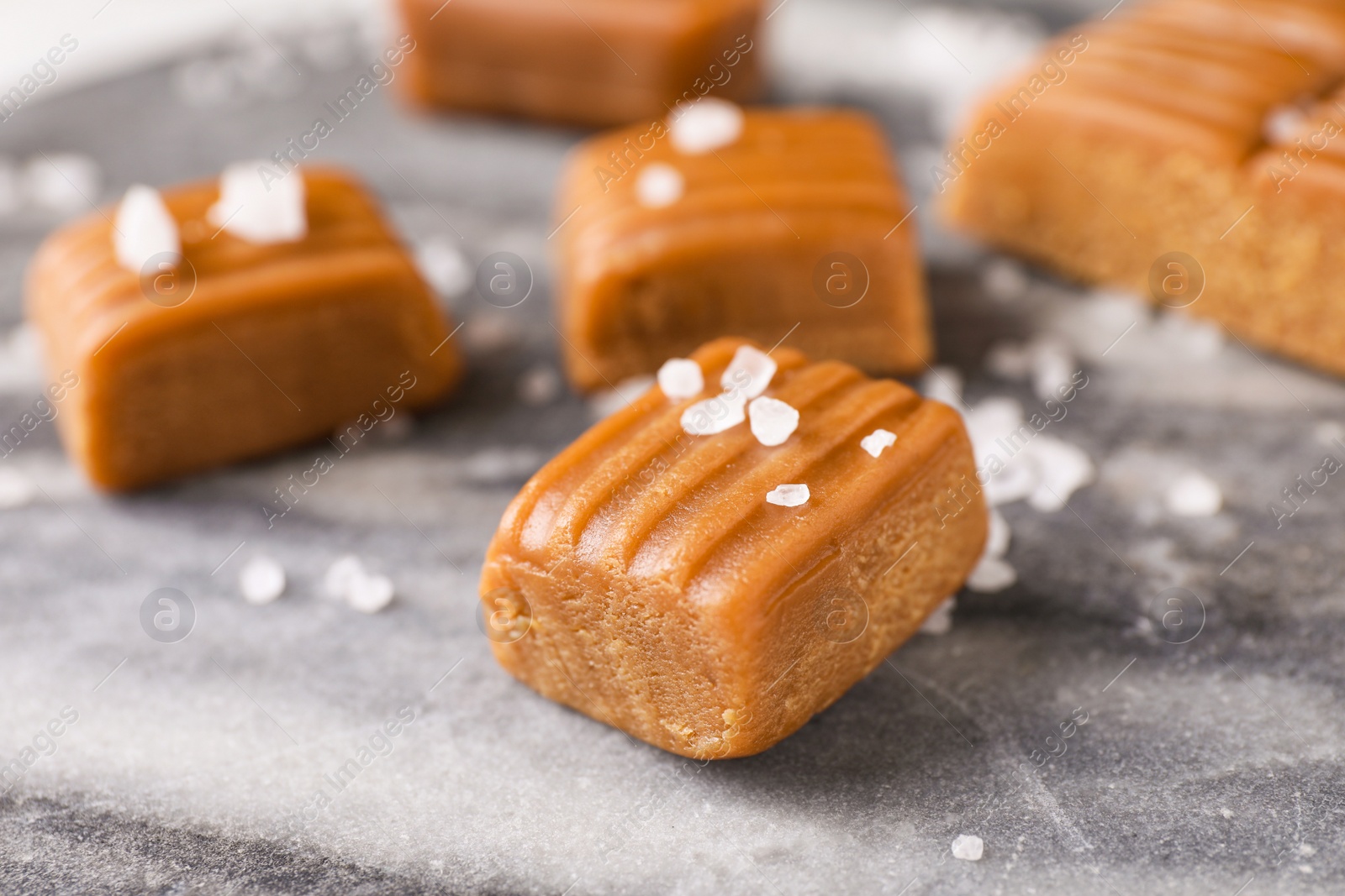 Photo of Salted caramel on marble table, closeup view