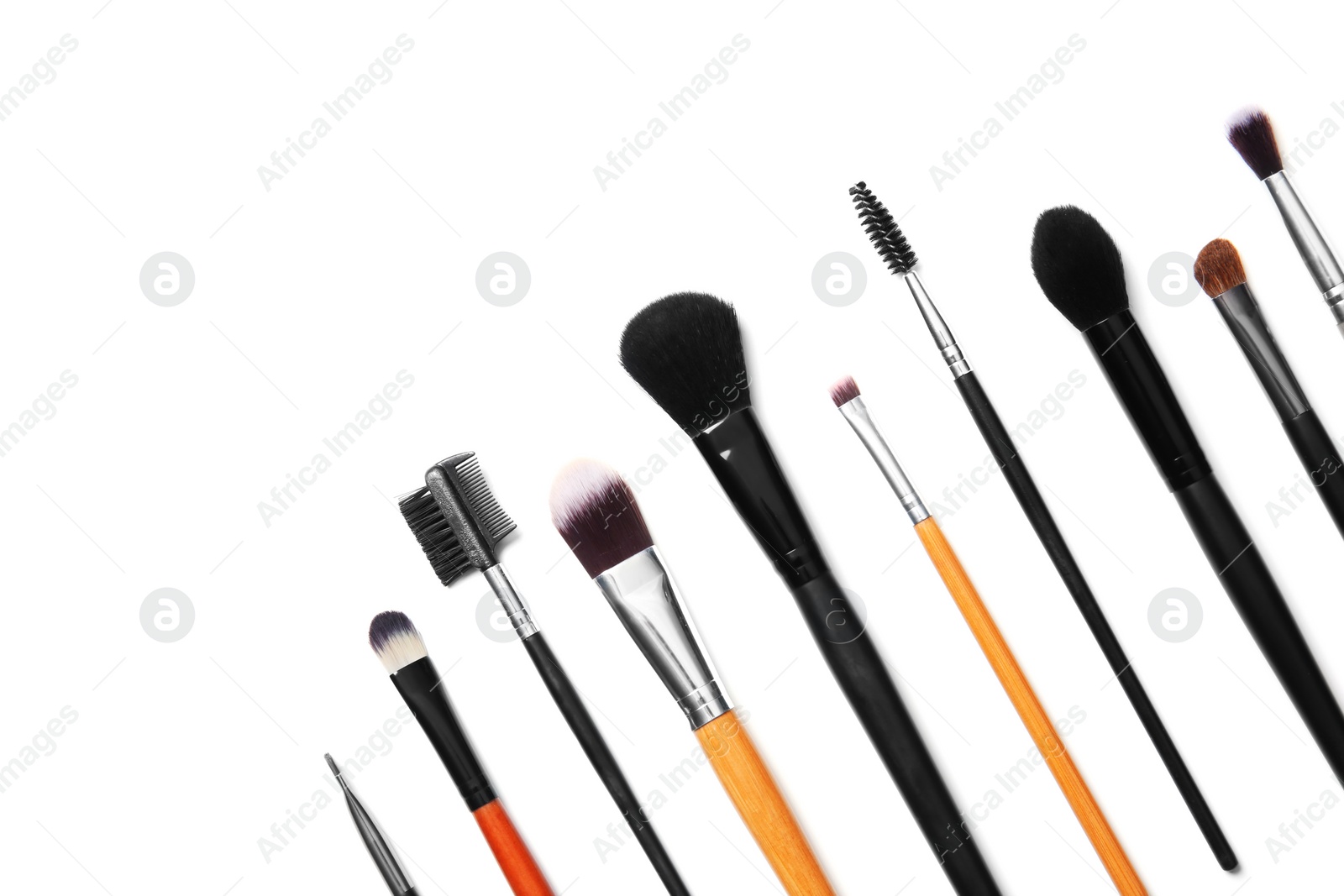 Photo of Flat lay composition with makeup brushes of professional artist on white background