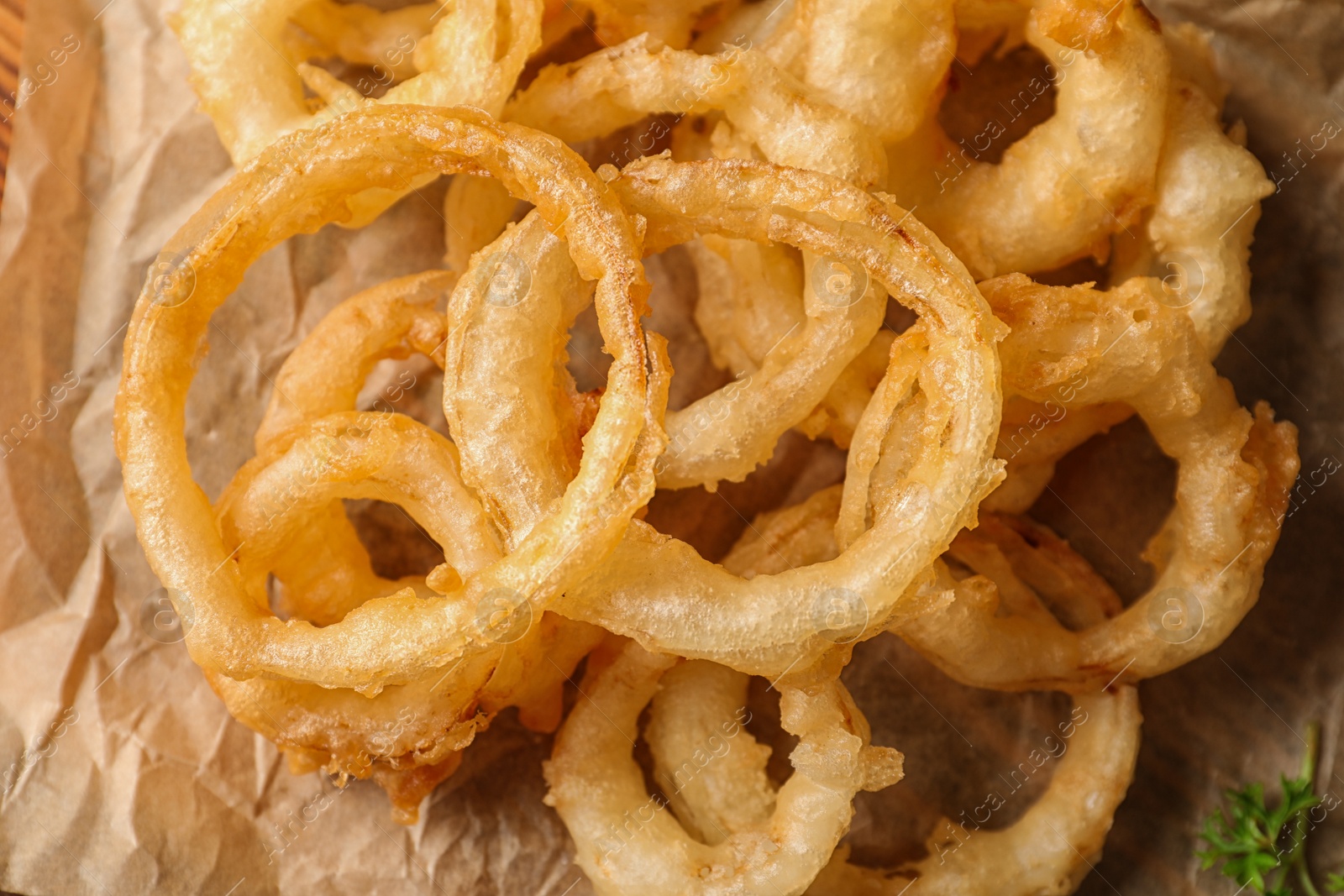 Photo of Homemade delicious golden breaded and deep fried crispy onion rings, closeup