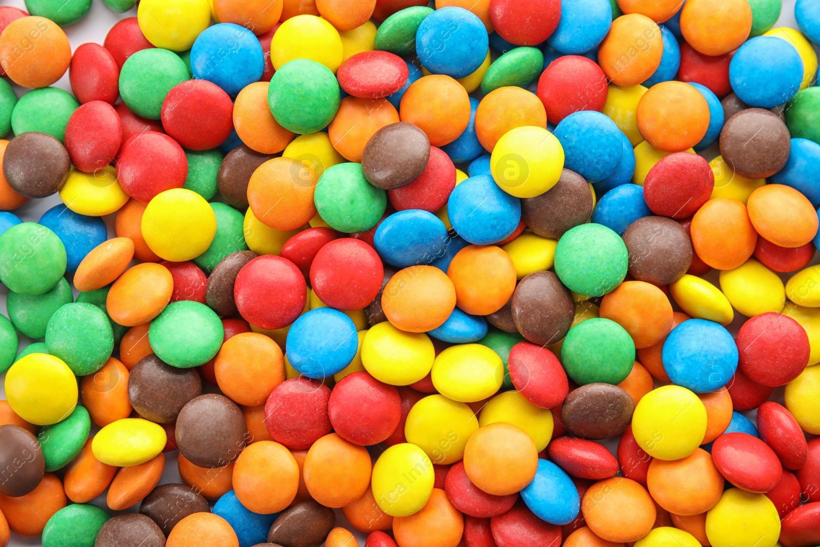 Photo of Many colorful candies as background, top view