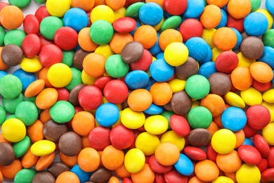 Many colorful candies as background, top view