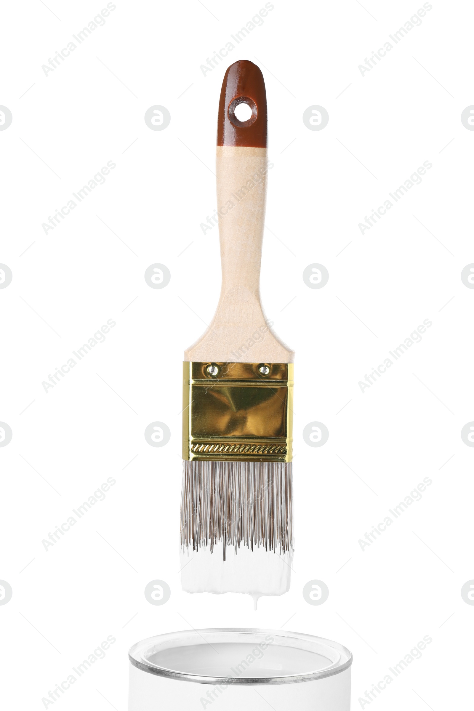 Photo of Brush with color paint over can isolated on white