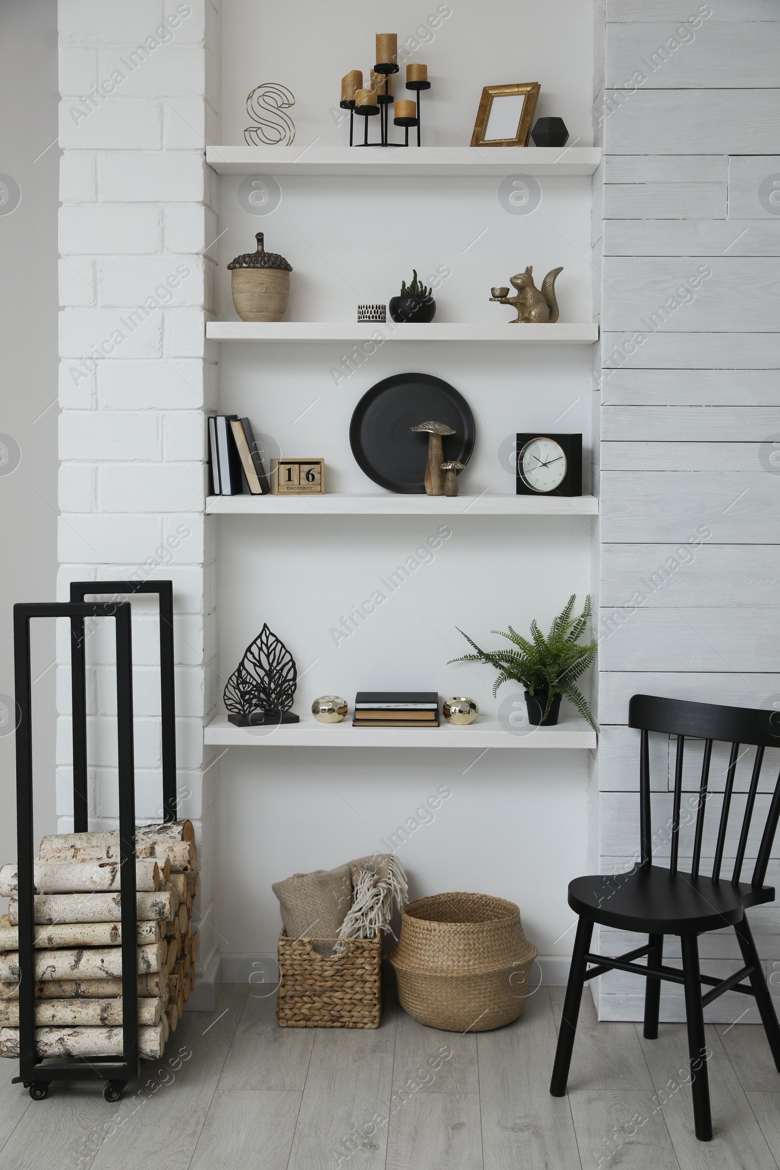 Photo of Many shelves with different decor in room. Interior design