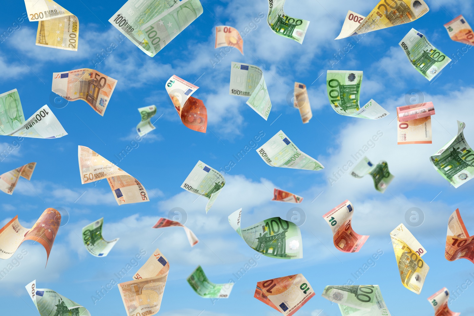 Image of Falling Euro banknotes and blue sky on background. Money rain