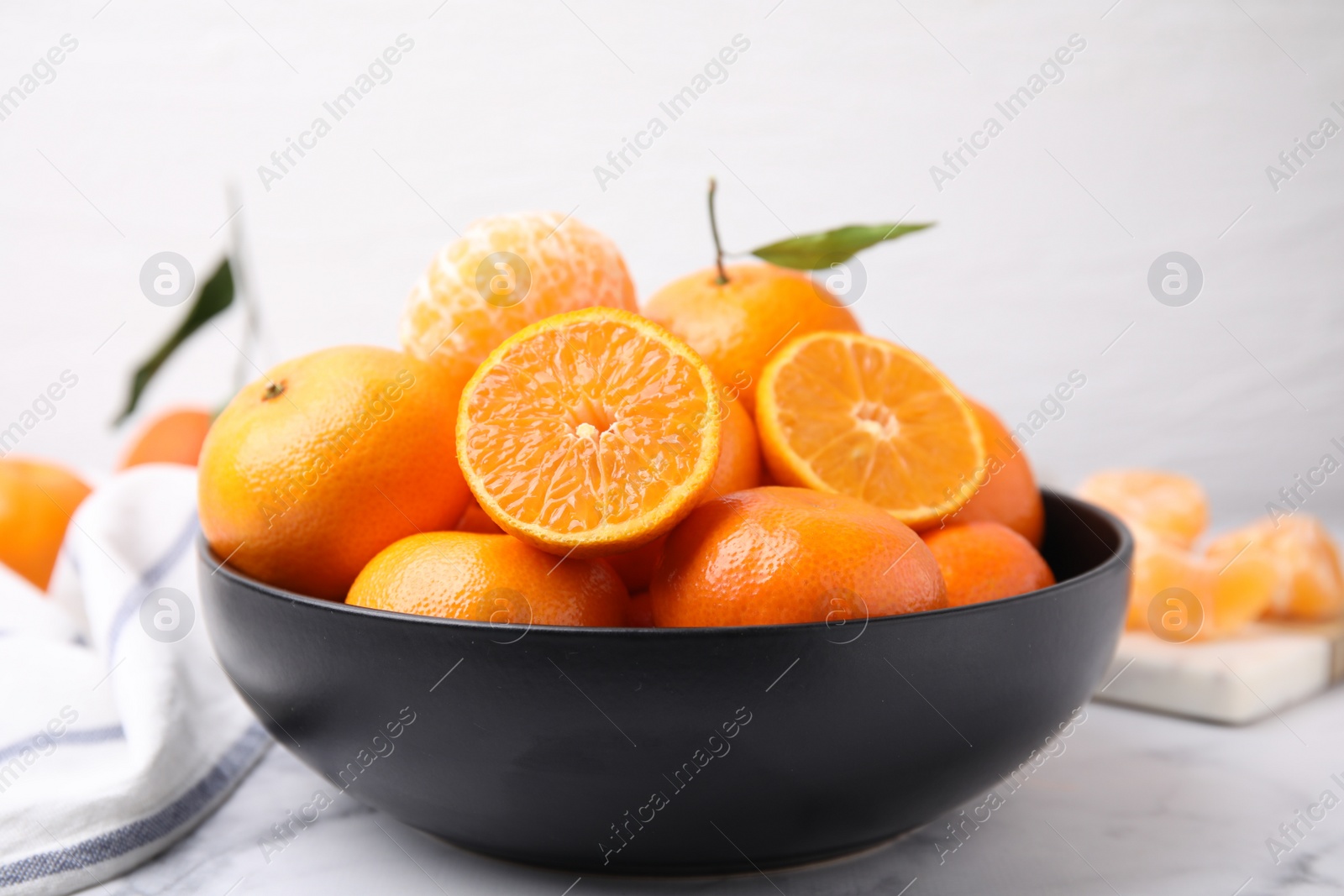 Photo of Fresh juicy tangerines on white marble table