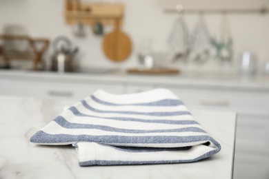 Photo of Clean towel on white marble countertop in kitchen