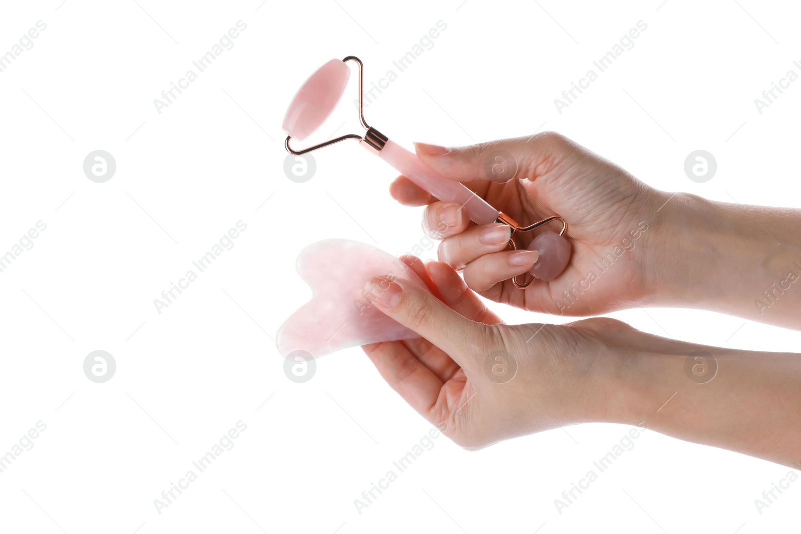Photo of Woman holding gua sha tool and face roller isolated on white, closeup