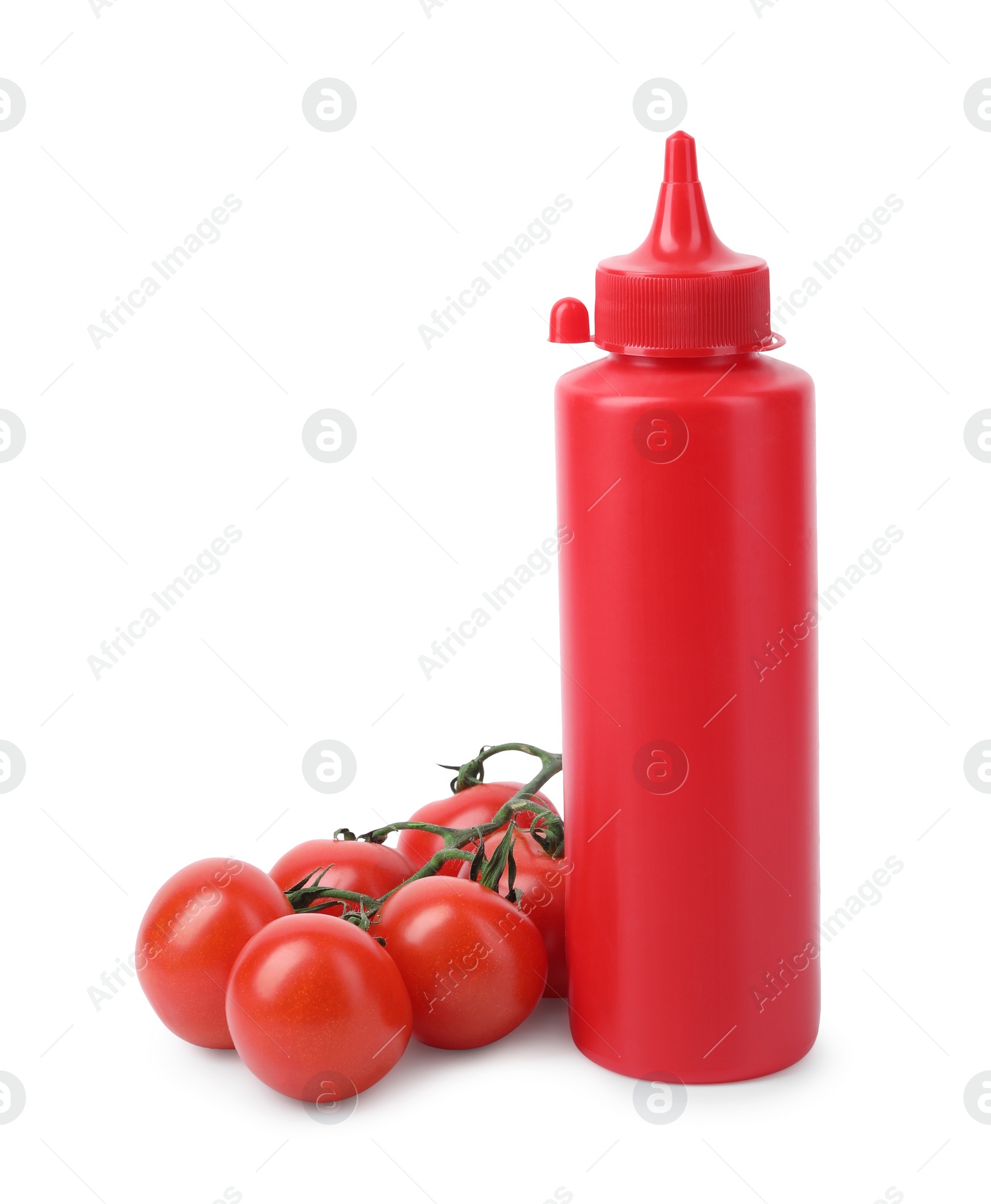 Photo of Bottle of tasty ketchup and fresh tomatoes isolated on white. Tomato sauce