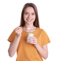 Young attractive woman with tasty yogurt on white background