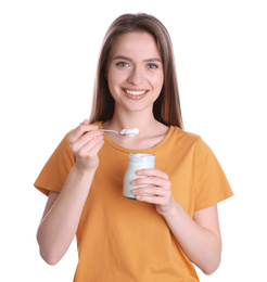 Photo of Young attractive woman with tasty yogurt on white background