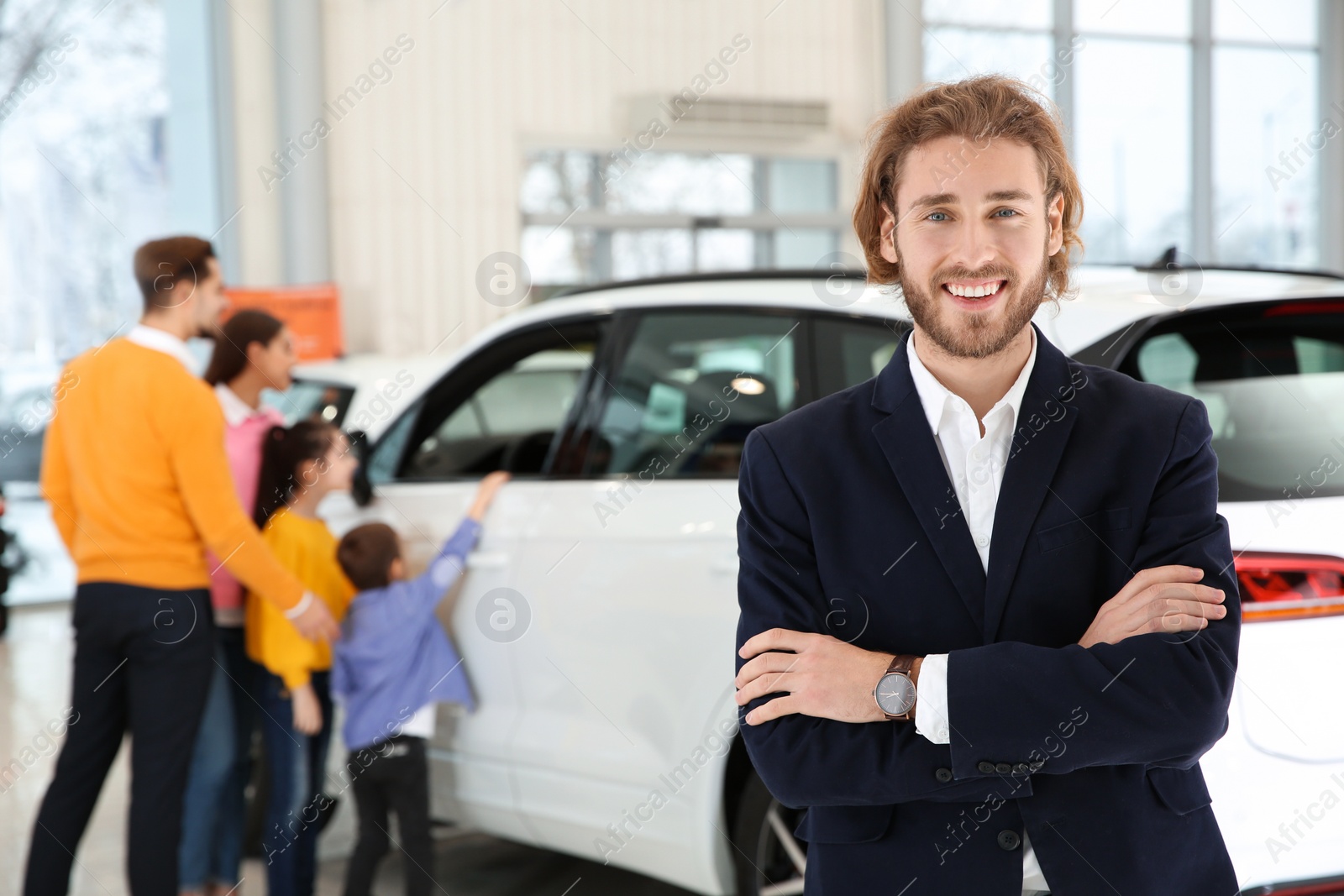 Photo of Car salesman and blurred family near auto on background