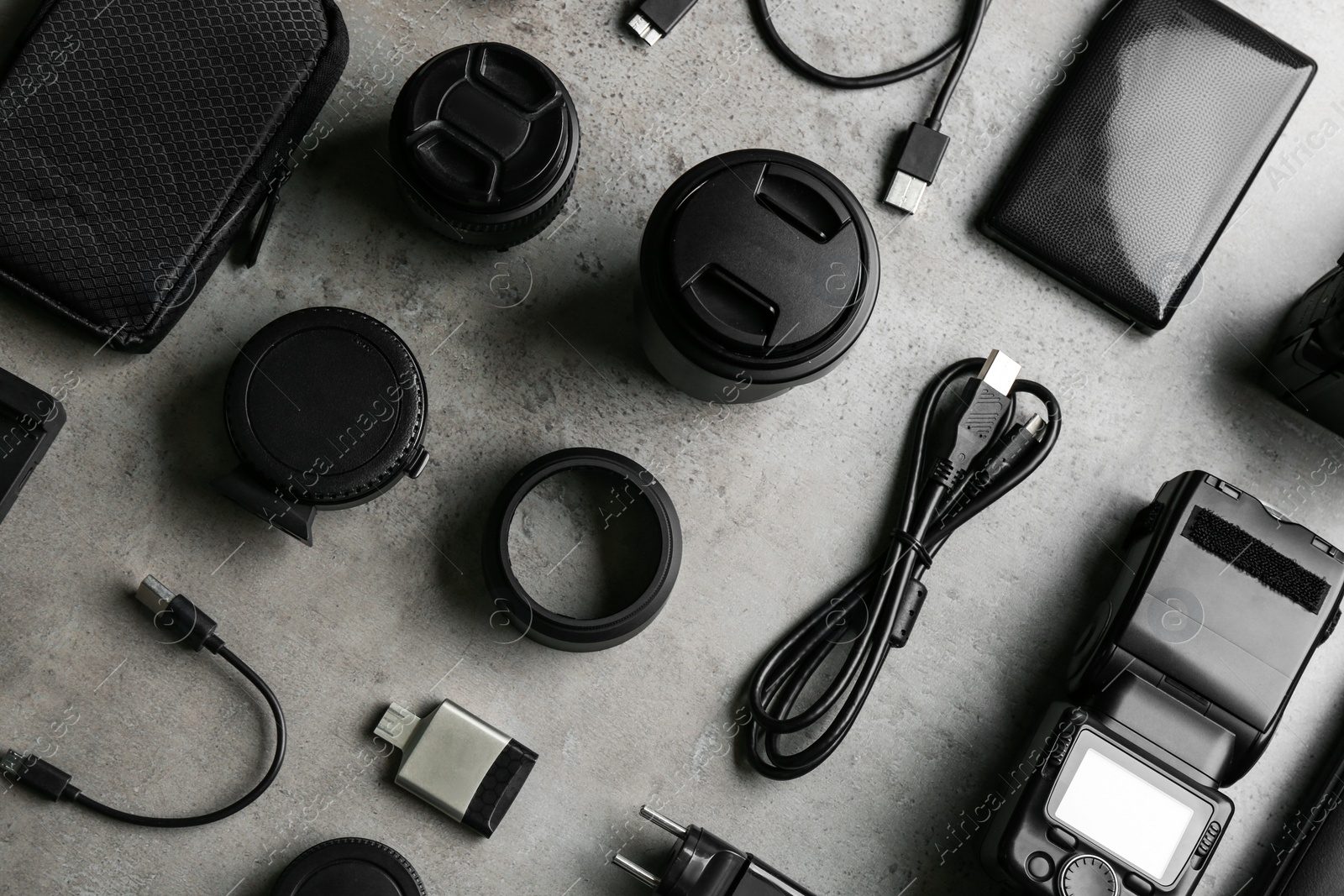 Photo of Flat lay composition with video production equipment for camera on light grey stone background