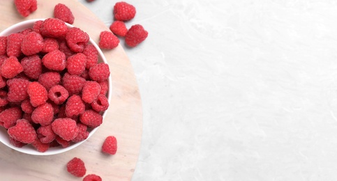 Photo of Delicious fresh ripe raspberries on light marble table, flat lay. Space for text