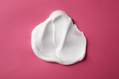 Sample of shaving foam on pink background, top view