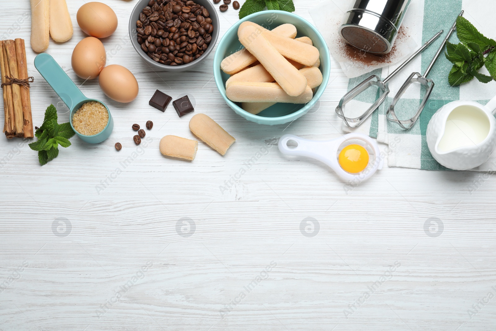 Photo of Flat lay composition with tiramisu ingredients on white wooden table, space for text