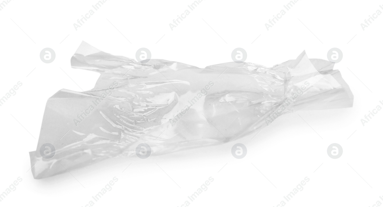 Photo of Crumpled transparent candy wrapper on white background