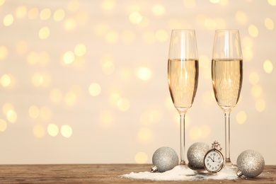 Photo of New year composition with champagne and space for text against blurred Christmas lights