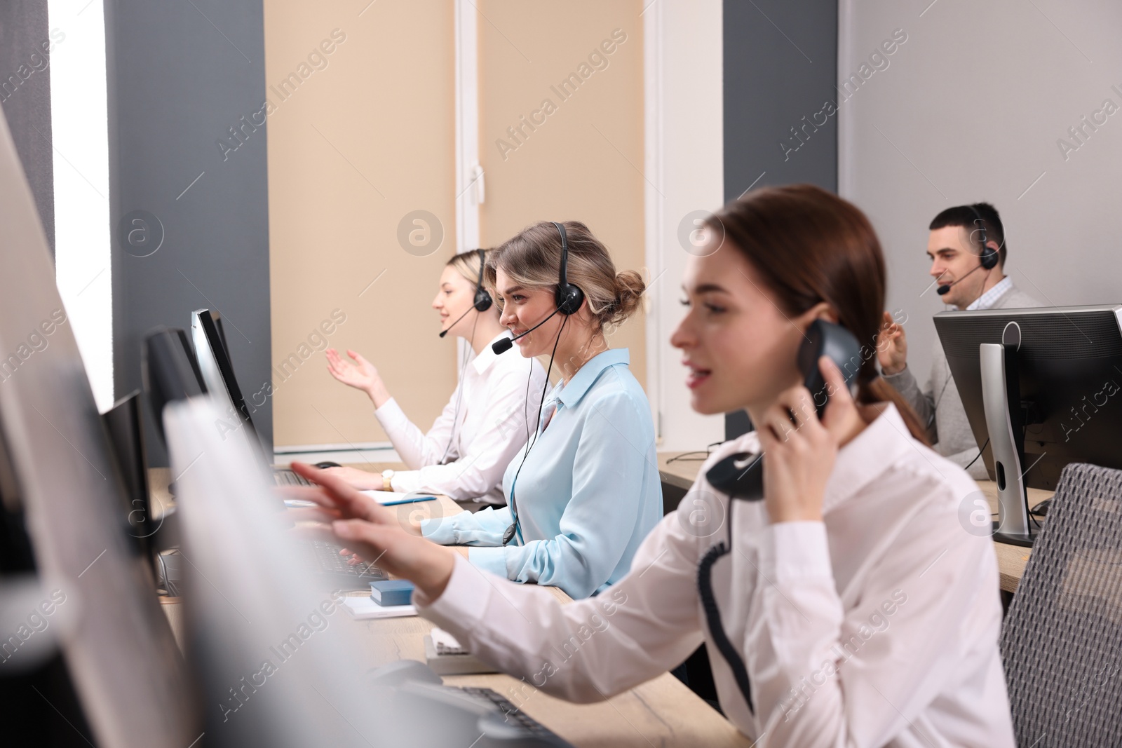 Photo of Call center operators working in modern office