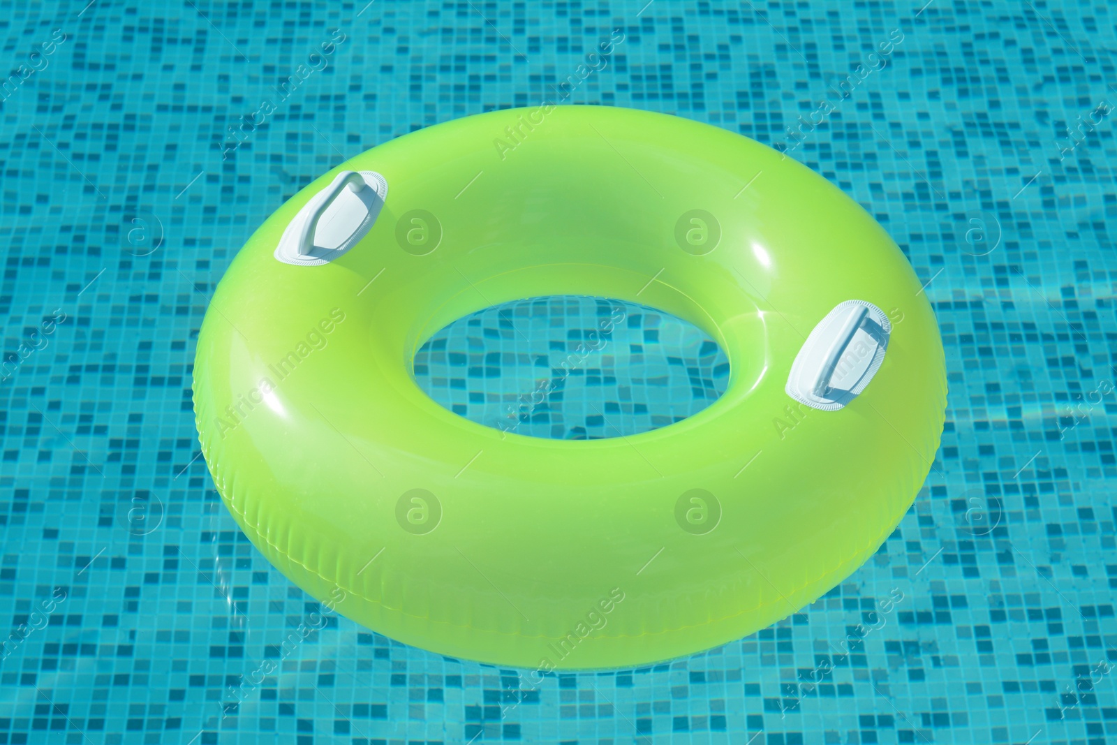 Photo of Light green inflatable ring floating in swimming pool