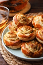 Fresh delicious puff pastry with tasty filling on wooden table, closeup