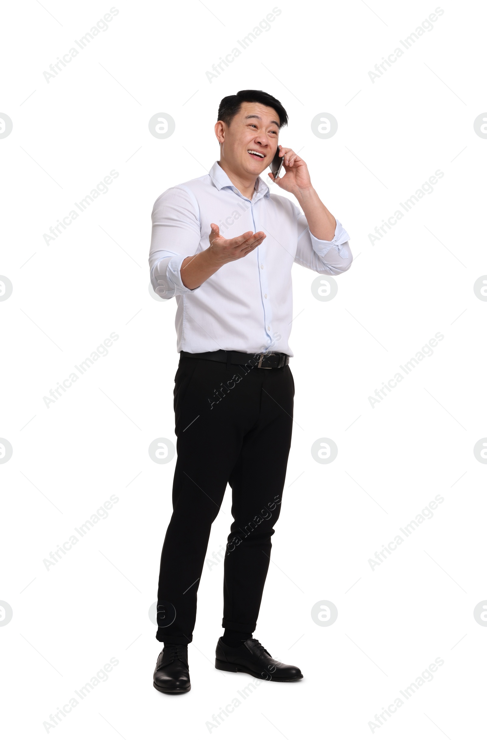 Photo of Businessman in formal clothes talking on phone against white background