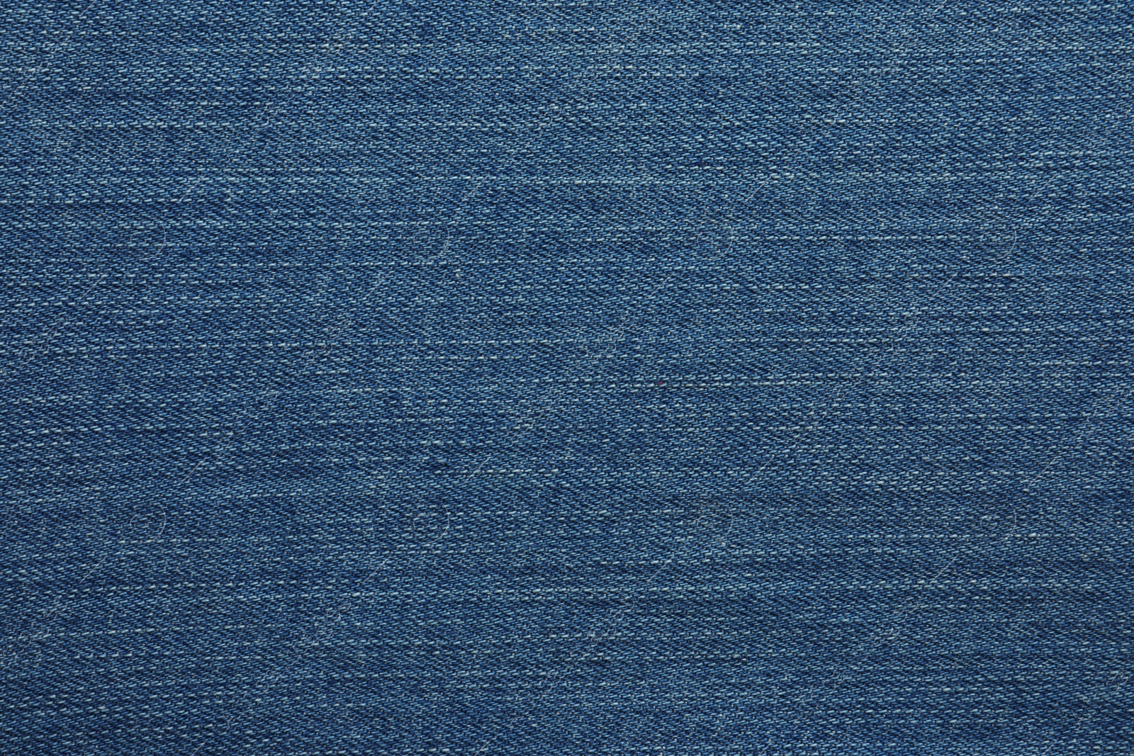 Photo of Texture of blue jeans as background, closeup