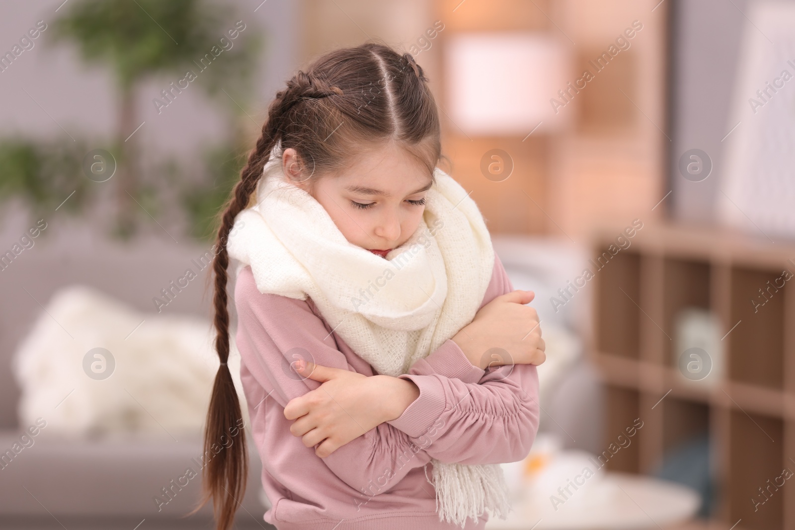 Photo of Sad little girl suffering from cold on blurred background