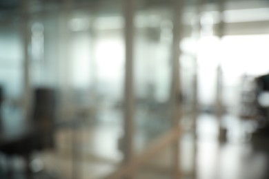 Blurred view of cozy workspaces with tables and chairs in office