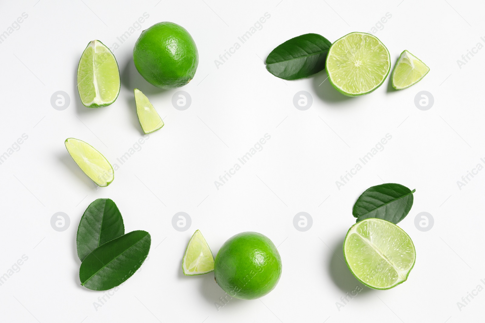 Photo of Fresh ripe limes and leaves on white background, flat lay. Space for text