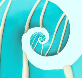 Image of Twisted donut with bright icing and topping on light background, spiral effect
