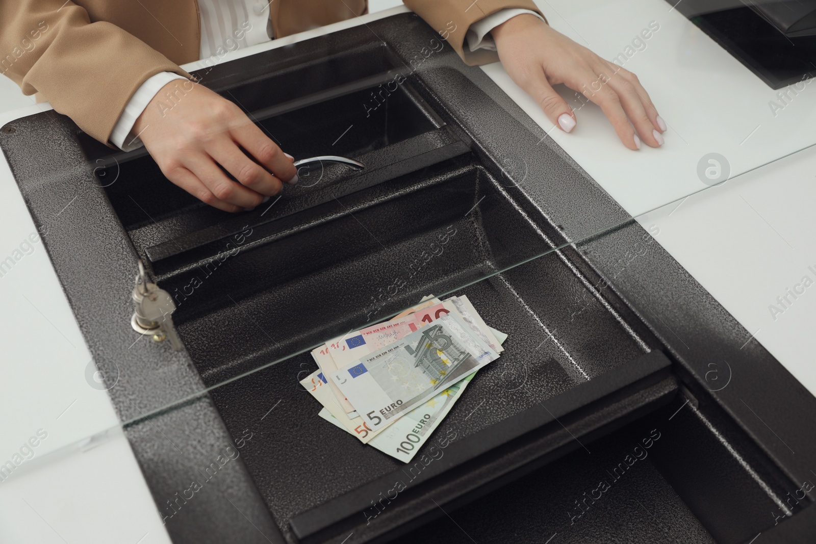 Photo of Cashier with money at bank, closeup. Currency exchange