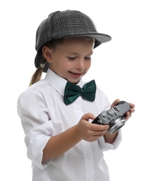 Photo of Cute little detective with vintage camera on white background