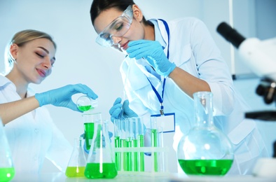 Female scientists working with sample in chemistry laboratory