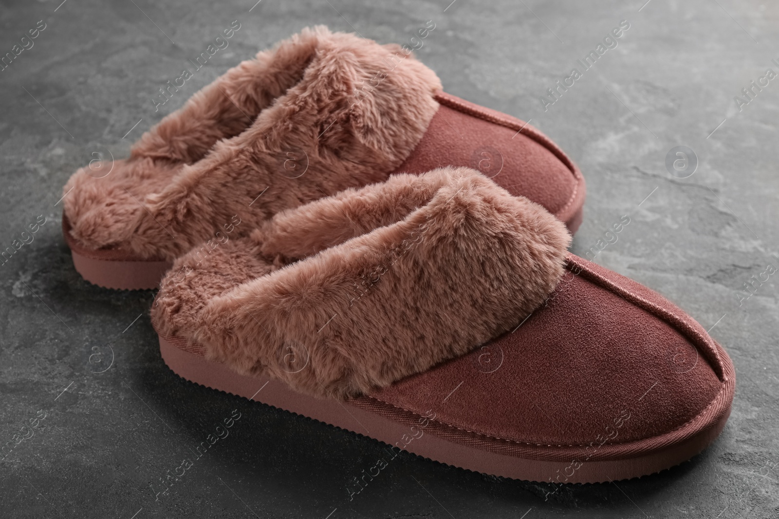 Photo of Pair of stylish soft slippers on grey background