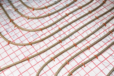 Photo of Installation of underfloor heating system in building