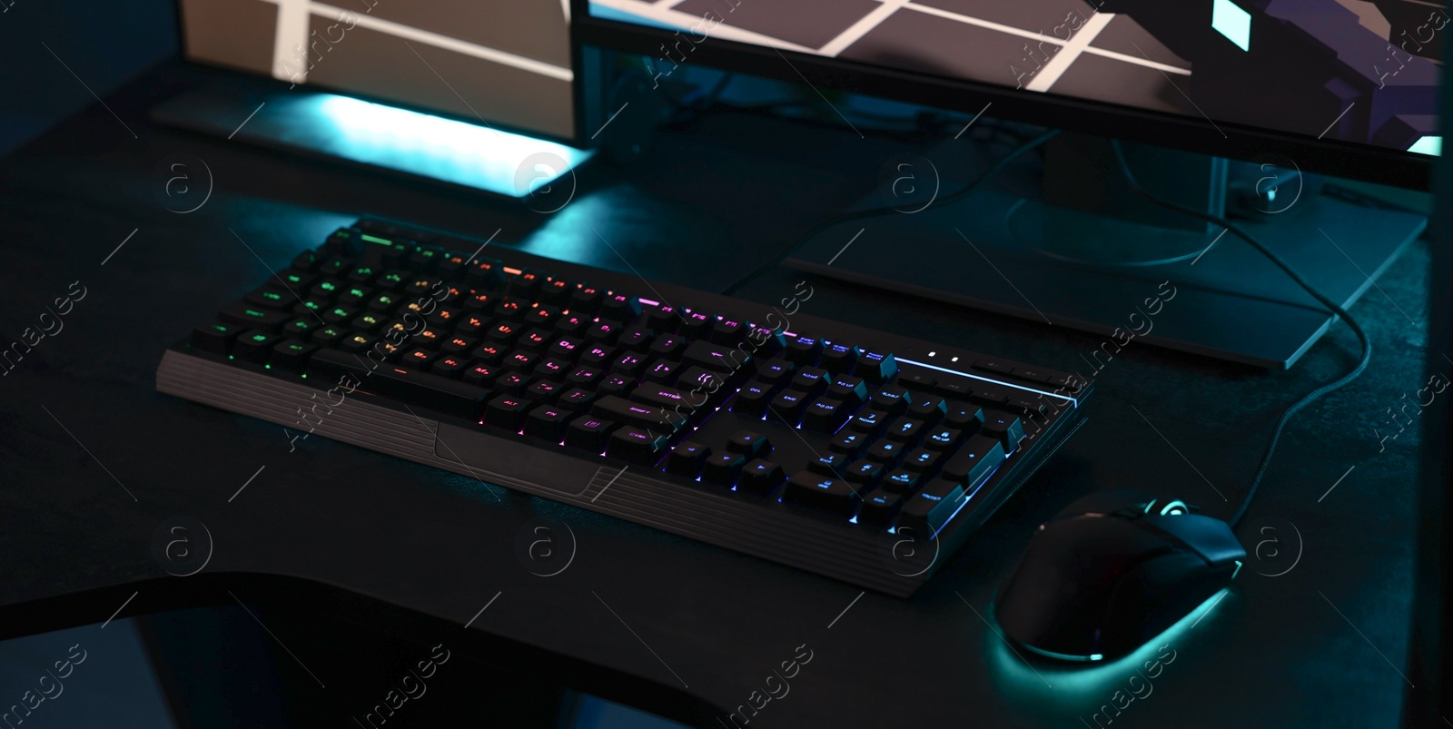 Photo of Playing video games. Computer monitor, keyboard and mouse on table indoors