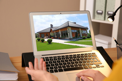 Image of Businesswoman or real estate agent looking through online property portfolio, closeup