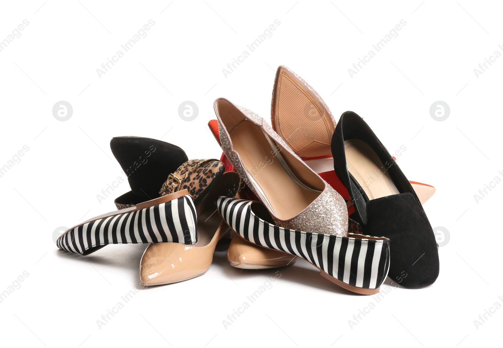 Photo of Pile of different shoes on white background