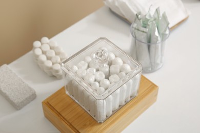 Holders with many tampons on white table, closeup. Menstrual hygienic product