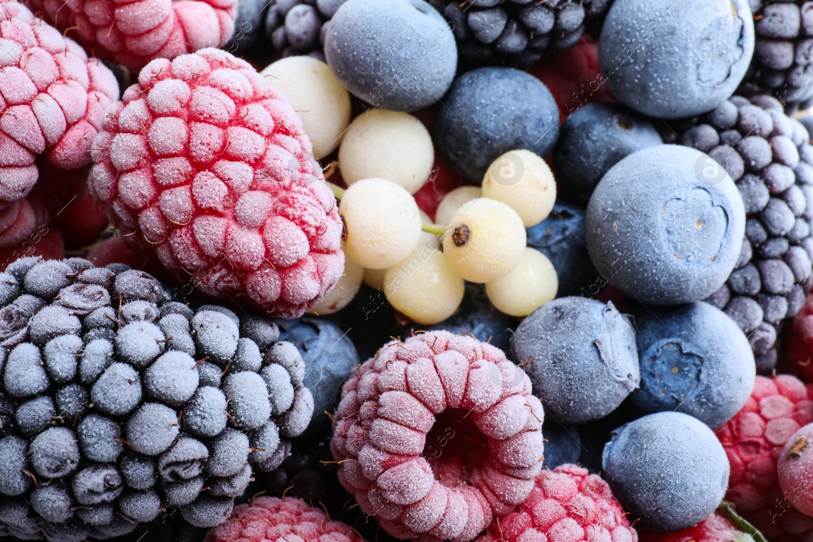 Photo of Mix of different frozen berries as background, top view