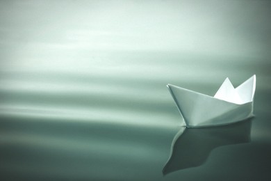 Image of White paper boat floating on river. Retro photo effect