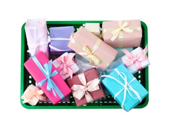 Shopping basket full of gift boxes on white background, top view